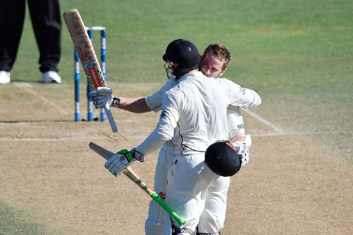 New Zealand’s captain Kane Williamson (R) celebrates his 100 runs with teammate Henry Nicholls during day five of their first Test against Bangladesh in Wellington Monday. - AFP