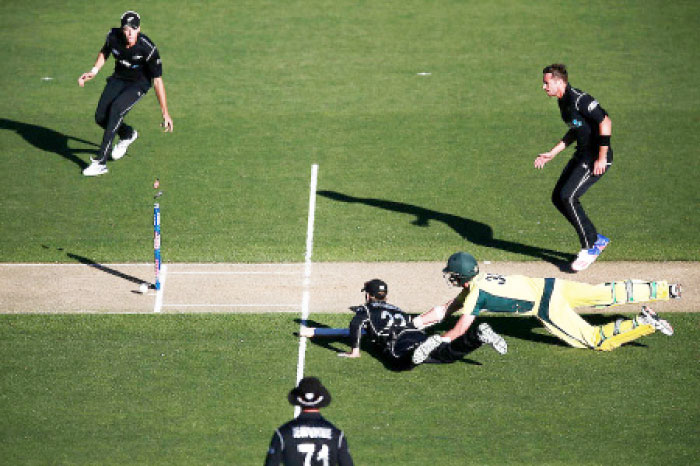 Kane Williamson of New Zealand runs out Josh Hazlewood of Australia to win their first One-Day International game in Auckland, New Zealand, Monday.