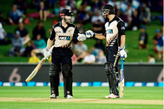 New Zealand’s captain Kane Williamson (L) celebrates hitting a six with teammate Colin de Grandhomme during their first Twenty20 match against Bangladesh in Napier Tuesday. - AFP