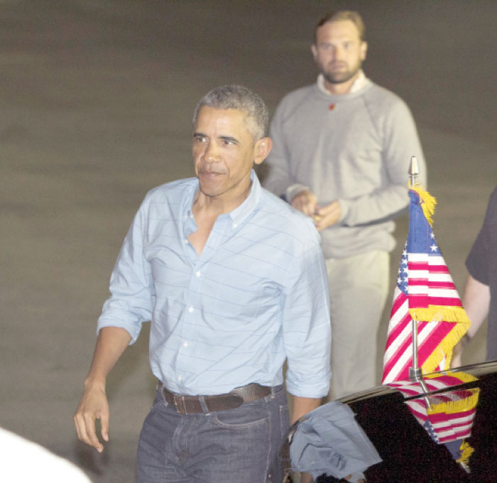 US President Barack Obama arrives at Joint Base Pearl Harbor-Hickam, adjacent to Honolulu, Hawaii, to board Air Force One en route to Washington, on Sunday, after his annual family vacation on the island of Oahu. — AP