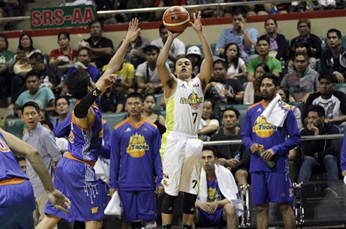 GlobalPort’s Terrence Romeo fires a three-pointer off TNT’s Roger Pogoy in their PBA Philippine Cup game Wednesday night at the Cuneta Astrodome.