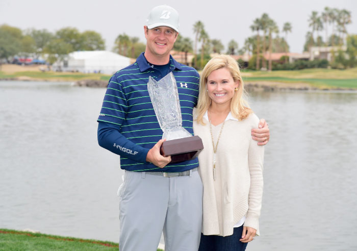 Hudson Swafford and his wife Katherine Wainwright Brandon pose with the trophy after the final round of the CareerBuilder Challenge at PGA West in La Quinta, California, Sunday. - AFP