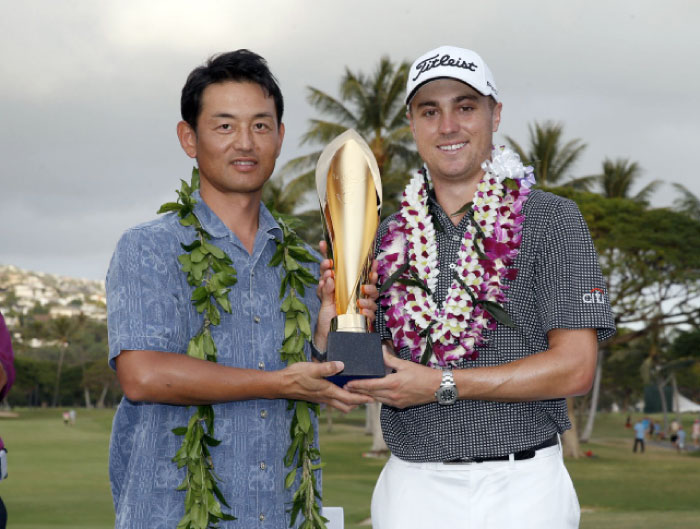 PGA golfer Justin Thomas accepts the trophy from Sony President after winning the Sony Open golf tournament at Waialae Country Club in Hawaii Sunday. - Reuters