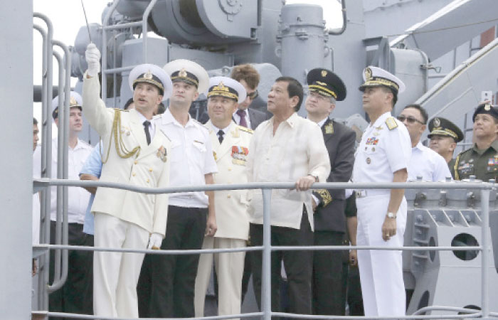 Philippine President Rodrigo Duterte, center, watches as Russian navy officers show the weapons on board the Russian anti-submarine Navy vessel Admiral Tributs in Manila, Philippines, in this Jan. 6, 2017, file photo. — AP