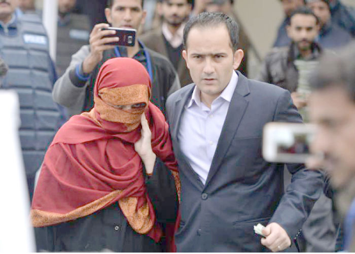 The wife, left, of a Pakistani judge is escorted by her brother as they leave the Supreme Court in Isla mabad in this Jan. 6, 2017 file photo. — AFP