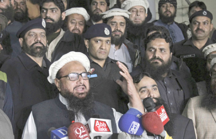 Hafiz Saeed, leader of the Pakistani religious group and charity, Jamaat-ud-Dawa, addresses his supporters outside the party’s headquarters, in Lahore, Pakistan, on Monday. — AP