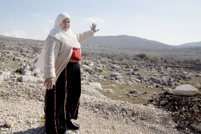 In this Jan. 1, 2017, photo, Maryam Abdel-Kareem, 82-year-old Palestinian, points to land held by the Jewish settlement of Amona, an unauthorized outpost in the West Bank, near the village of Silwad, east of the West Bank city Ramallah. — AP