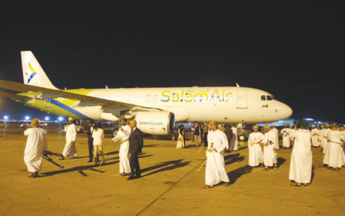 Omanis take photos on the tarmac during the unveiling of SalamAir, Oman›s new low-cost airline, at the Muscat International Airport in the Omani capital on Sunday. — AFP