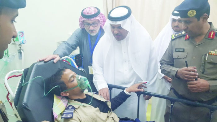 Officials visit a security guard who was injured during the fire at King Faisal Hospital in Taif.