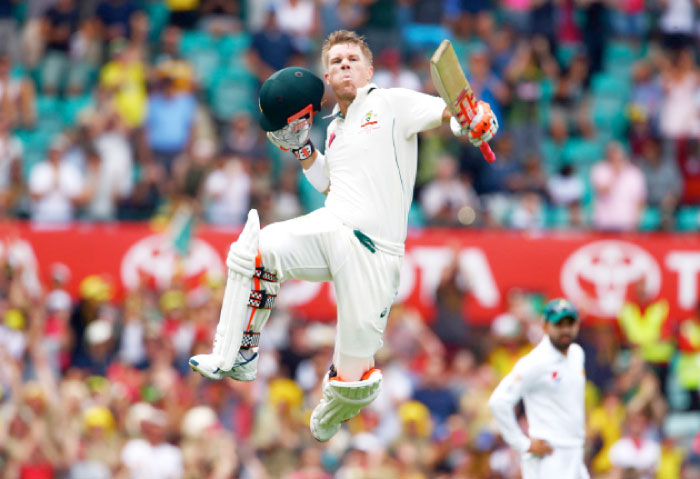 Australia’s David Warner celebrates after scoring a century against Pakistan in Sydney Tuesday. - Reuters