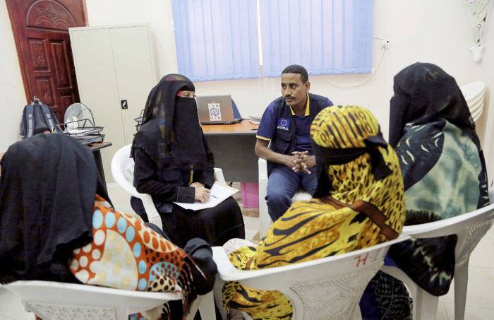 In this photo taken on Monday, Jan. 2, 2017, an employee speaks to Ethiopian migrants at International Organization for Migration center in the port city of Aden, Yemen. — AP