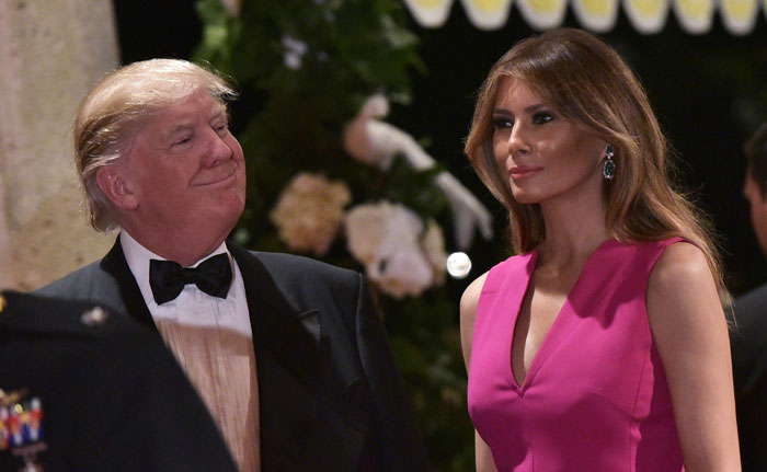 US President Donald Trump and First Lady Melania Trump arrive for the 60th Annual Red Cross Gala at his Mar-a-Lago estate in Palm Beach on Saturday. — AFP