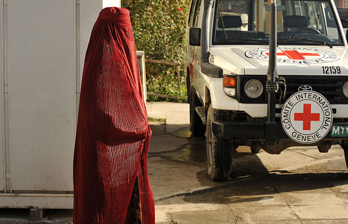 sIn this file photograph, an Afghan pedestrain walks past a vehicle at the International Committee for the Red Cross (ICRC) office in Kabul. Six Red Cross workers were killed and two others were missing in northern Afghanistan, the international charity said Wednesday. — AFP