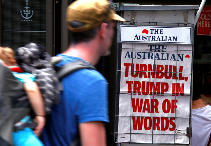 A pedestrian looks at a newspaper headline regarding US President Donald Trump and Australian Prime Minister Malcolm Turnbull in central Sydney, Australia. — Reuters