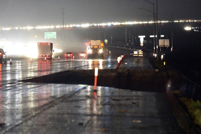 A section of southbound Interstate 15 just south of Hwy 138 is washed away in the Cajon Pass, California, on Friday. — AP
