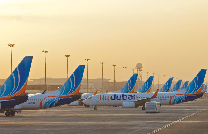 Aircraft pushing back from a row at the gate.