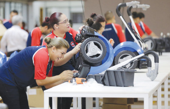 Workers assemble riding toys of Brazilian toymaker Estrela at a factory in Hernandarias, Paraguay. — Reuters