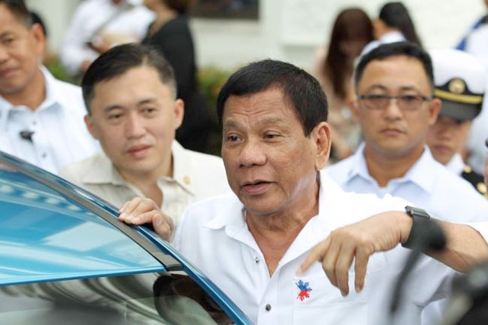 Philippine President Rodrigo Duterte (C) speaking to reporters during the launch of the first Japanese car manufacturer assembled in the country at Malacanang Palace in Manila. — AFP