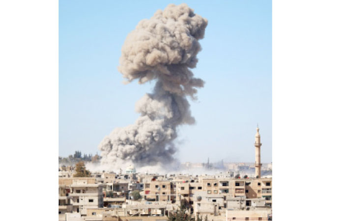 Smoke billows following a reported car bomb explosion at a Syrian pro-government position during clashes between rebel fighters and regime forces to take control of an area in the southern city of Daraa on February 20. — AFP
