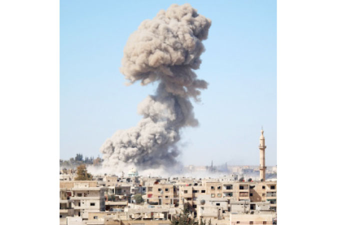 Smoke billows following a reported car bomb explosion at a Syrian pro-government position during clashes between rebel fighters and regime forces to take control of an area in the southern city of Daraa on February 20. — AFP