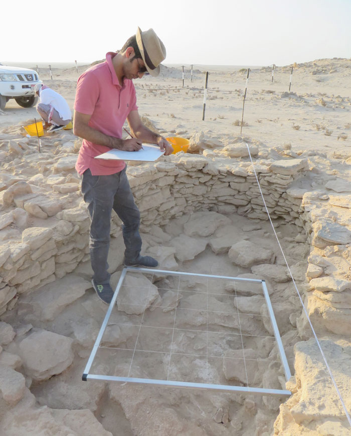 An archeologist records a 7,000-year old house on the island of Marawah.