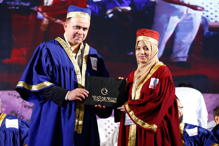 Rector Dr. Abdussalam Ahmed distributes degrees to the university’s graduates. Nearly 300 graduates including 60 women received certificates during the event.