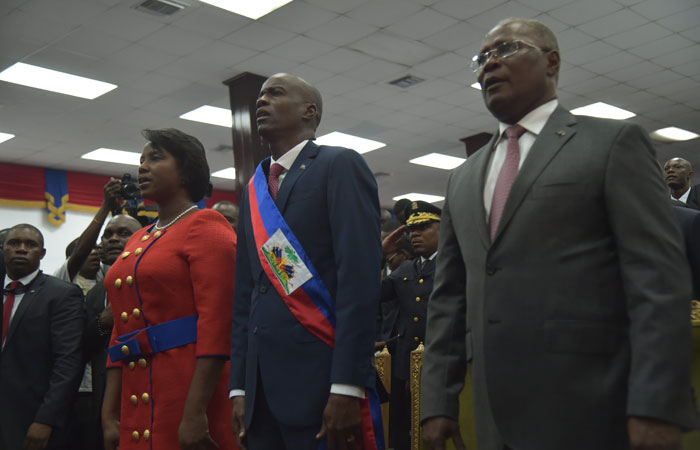 New Haitian President Jovenel Moise(C) stands after receiving his sash, during his Inauguration, at the Haitian Parliament in Port-au-Prince, on Tuesday. Jovenel Moise was sworn in Tuesday as Haiti's 58th president, ending a protracted electoral crisis that had created a vacuum of power in the impoverished, disaster-prone Caribbean nation. — AFP