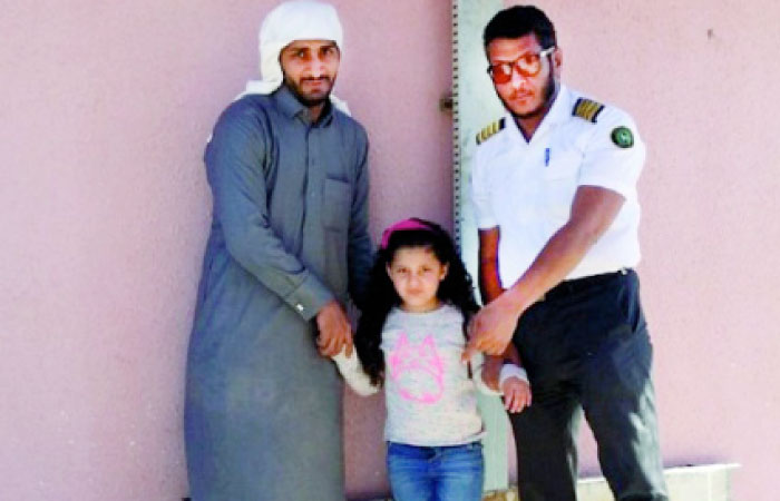 The father and sister of the drowned boy with a security officer. — Okaz photo