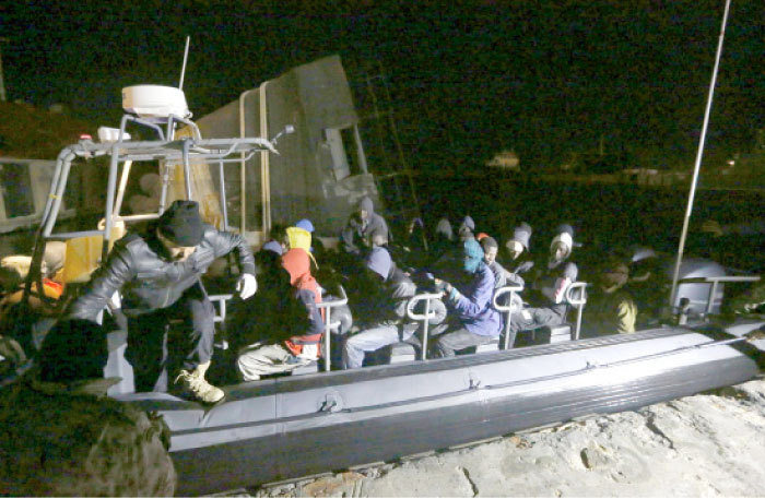 Libyan coast guard police help Illegal immigrants who were rescued at sea off the coast of Libya, get off a boat in the capital Tripoli, in the early hours of Sunday. — AFP