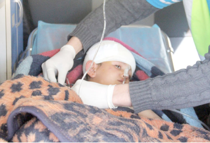 Nine-year-old Syrian Abdel Basset Al-Satuf is seen inside an ambulance in the town of Al-Hbeit, in northwest Idlib province as he is being transferred to Turkey for medical treatment. — AFP