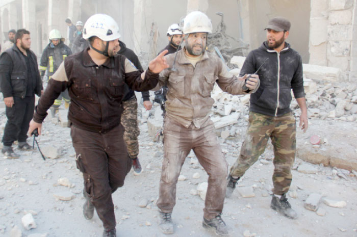 A member of the Syrian volunteers known as the White Helmets reacts after an air strike during a rescue operation in the rebel-held town of Binnish, on the outskirts of Idlib, on Saturday. — Reuters