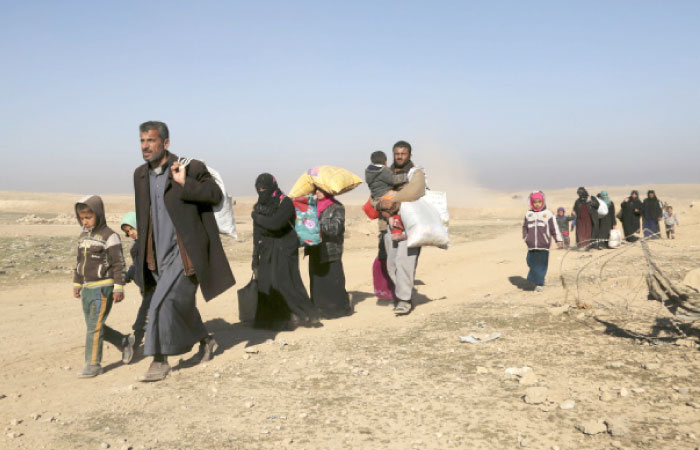 Displaced Iraqis flee their homes due to fighting between Iraqi special forces and Daesh militants, on the western side of Mosul, Iraq, Saturday. — AP