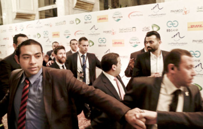 FC Barcelona’s Lionel Messi, center, leaves after a gala dinner held at the Mena House in Giza, Egypt, Tuesday. Soccer player Messi is in Egypt to promote the Tour n’ Cure initiatives which aims to attract Hepatitis C patients from all around the world to seek treatment in Egypt. — AP
