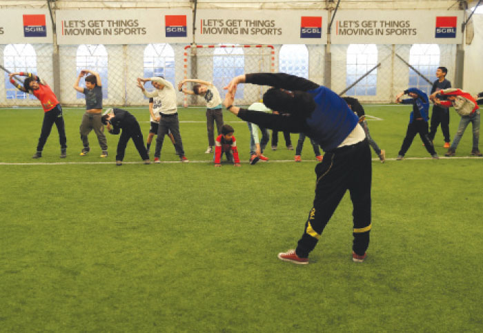 Syrian refugee boys practice before they start their games at a private sports club in southern Beirut, Lebanon. — AP