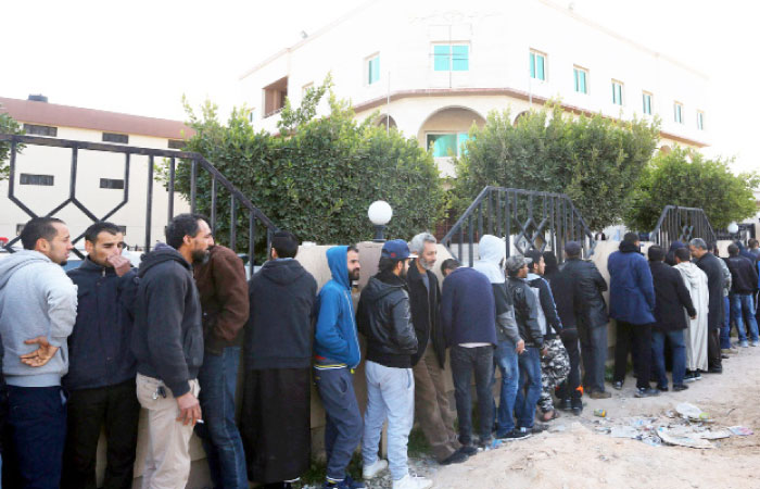 Libyans wait to enter a bank in the capital Tripoli. Libya’s transition has been bogged down by insecurity and chaos, leaving the country looking like a “failed state” six years after the NATO-backed uprising that ended Moammar Gaddafi’s rule. — AFP