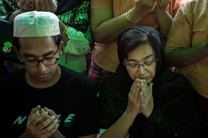 Relatives of murdered Myanmar lawyer Ko Ni pray during a memorial ceremony in Yangon on Saturday. The joint Muslim and Buddhist ceremony was held for Ko Ni and a taxi driver who was killed while trying to intervene, as a second suspect was arrested over the brazen murder of the prominent Muslim lawyer. — AFP
