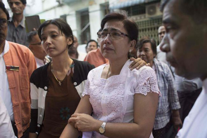 Tin Tin Aye, center right, the wife of prominent Muslim lawyer Ko Ni, and their daughter, center left, are pictured at the family home in Yangon on Jan. 30, 2017 the day after Ko Ni was shot dead. — AFP