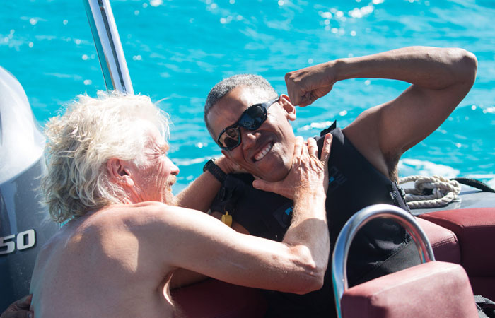 Former US President Barack Obama and British businessman Richard Branson sit on a boat during Obama's holiday on Branson's Moskito island, in the British Virgin Islands, in a picture handed out by Virgin on Tuesday. — Reuters