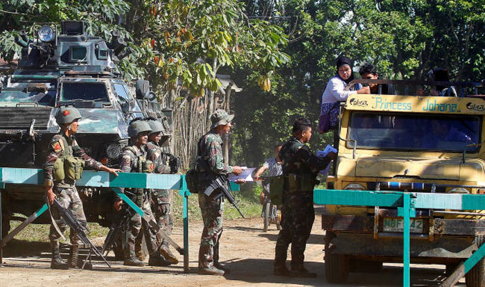 Soldiers distribute pictures of a member of extremist group Abu Sayyaf Isnilon Hapilon, who has a US government bounty of $5 million for his capture, at a checkpoint in Butig, Lanao del Sur in southern Philippines in this Feb. 1, 2017 file photo. — Reuters