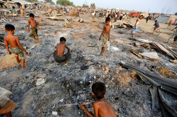 Boys search for useful items among the ashes of burnt houses after fire destroyed shelters at a camp for internally displaced Rohingya Muslims in the western Rakhine State near Sittwe, Myanmar, in this May 3, 2016 file photo. — Reuters