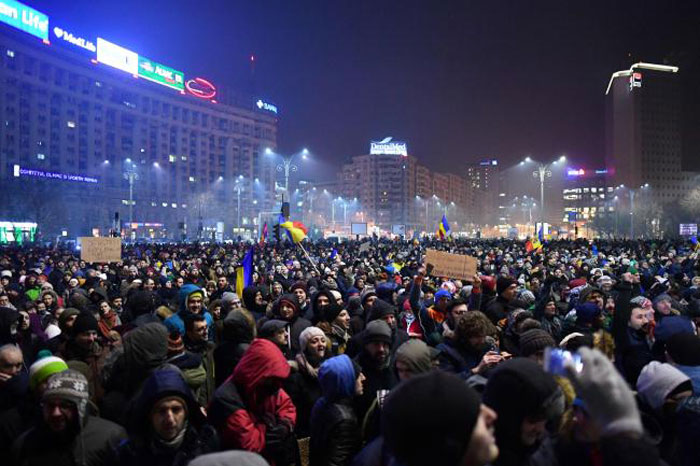 People demonstrate in front of Romanian Government headquarters against controversial decrees to pardon corrupt politicians and decriminalize other offenses in Bucharest on Tuesday. — AFP