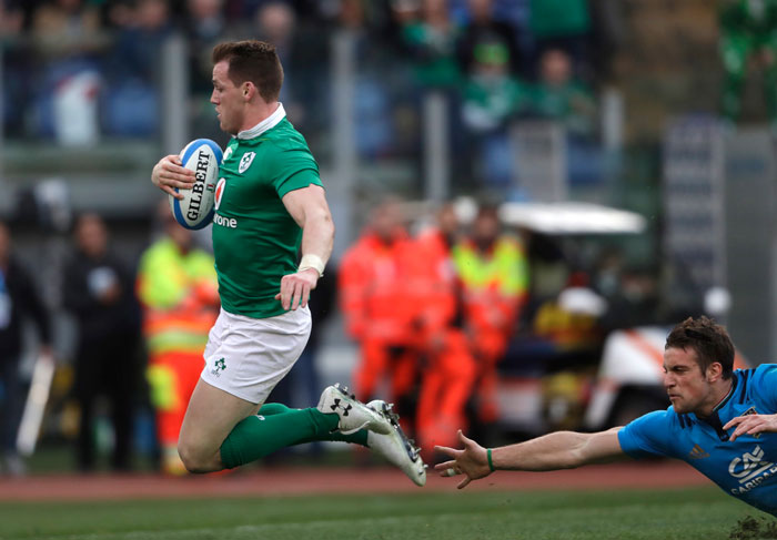 Ireland's Craig Gilroy (L) scores a try as Italy’s Edoardo Padovani tries unsuccessfully to stop him during a Six Nations rugby union international match at the Rome Olympic Stadium Saturday. — AP