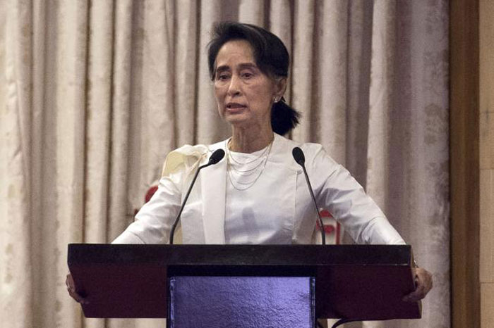 Myanmar’s State Counselor Aung San Suu Kyi speaks during a memorial ceremony for murdered lawyer Ko Ni and taxi driver Ne Win in Yangon on Sunday. — AFP