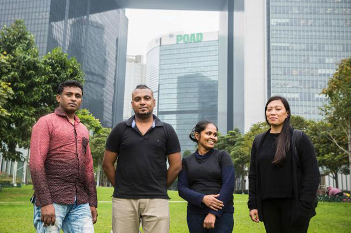 Sri Lankan refugee Ajith Puspa, left, 45, Sri Lankan refugee Supun Thilina Kellapatha, second left, 32, his partner Nadeeka, second right, 32, and Filipino refugee Vanessa Rodel, right, 40, pose for a photo in front of the government buildings of Hong Kong in this file photo. — AFP