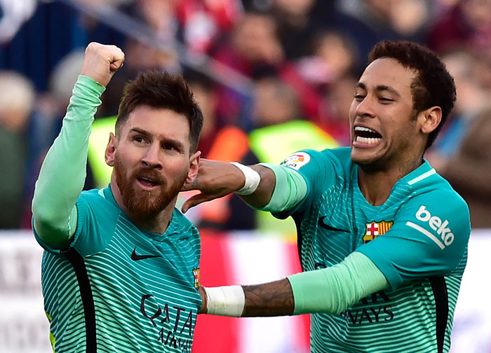 Barcelona's Lionel Messi (L) celebrates a goal with teammate Neymar during their Spanish league football match against Atletico de Madrid at the Vicente Calderon Stadium in Madrid Sunday. — AFP