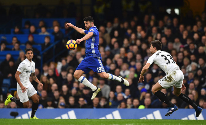 Chelsea's striker Diego Costa (C) controls the ball during the English Premier League football match against Swansea at Stamford Bridge in London Saturday. — AFP