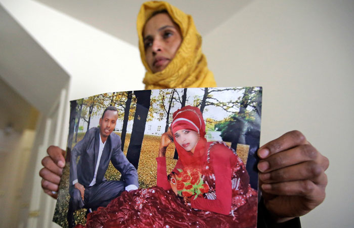 In this file photo, Somali refugee Nimo Hashi holds a photo of her husband in Salt Lake City. But he won't be arriving as planned to see her and the 2-year-old daughter he's never met. He was among hundreds of people stuck in limbo after President Donald Trump's executive order temporarily banned refugees and nearly all travelers from seven Muslim-majority countries, including Somalia. — AP