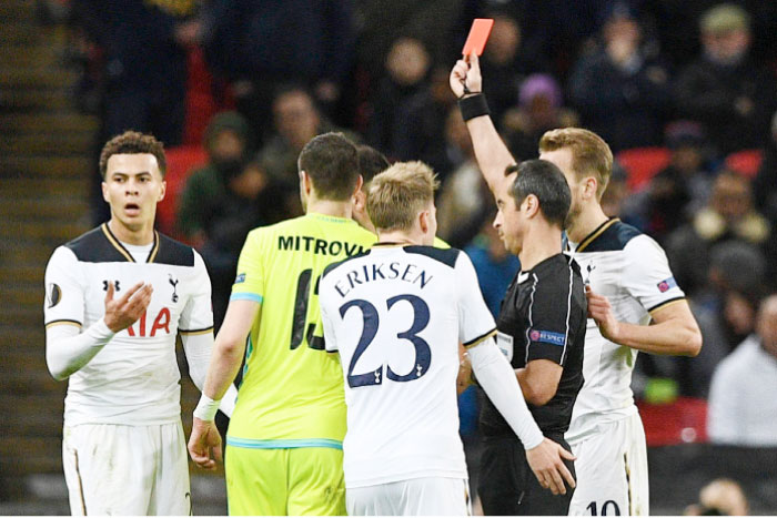 Portuguese referee Jorge Sousa (R) shows a straight red card to send off Tottenham Hotspur’s English midfielder Dele Alli (L) during the UEFA Europa League Round of 32 second-leg match against KAA Gent at Wembley Stadium in London Thursday. — AFP