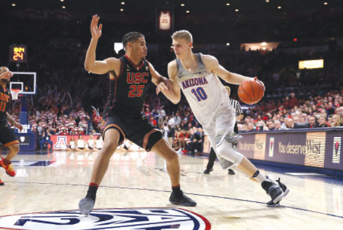 Bennie Boatwright (L) of the USC Trojans defends against Lauri Markkanen of the Arizona Wildcats during their college basketball game at McKale Center in Tucson, Arizona, Thursday. — AFP