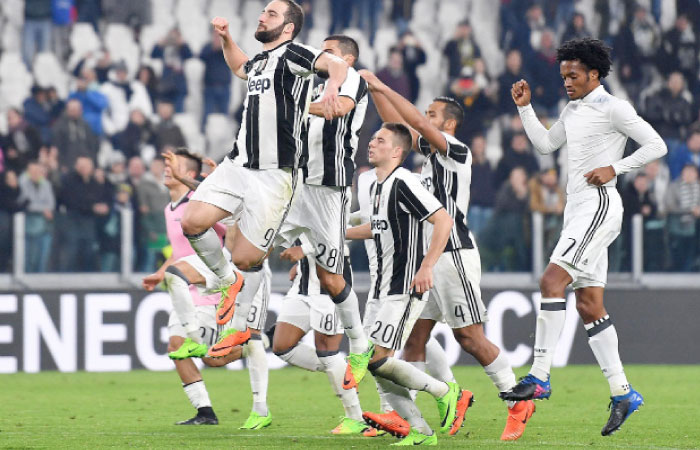 Juventus’ players, including Gonzalo Higuain (L), celebrate at the end of their Serie A match against Palermo at the Juventus Stadium in Turin Friday. — AP